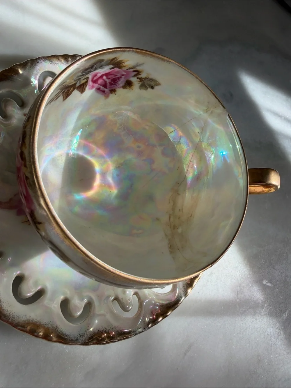 Iridescent Porcelain Teacup and Saucer with Pink Rose Motif and Gold Trim